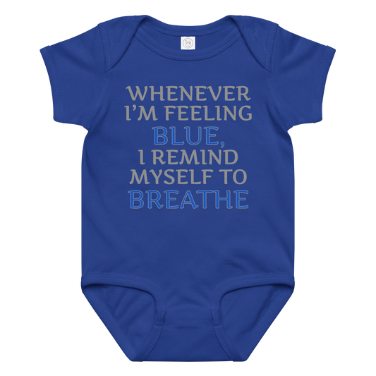"Whenever I'm feeling blue, I remind myself to breathe" printed on a royal baby jersey bodysuit laying on a flat surface amongst other clothes