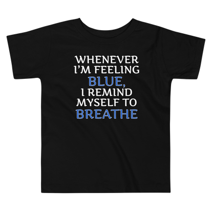 "Whenever I'm feeling blue, I remind myself to breathe" printed on a black toddler short sleeve tee laying on a flat surface
