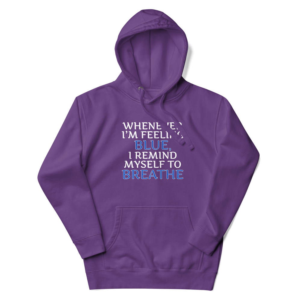 "Whenever I'm feeling blue, I remind myself to breathe" printed on a purple unisex hoodie laying on a flat surface with the hood up