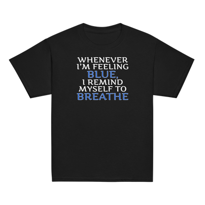 "Whenever I'm feeling blue, I remind myself to breathe" printed on a black youth classic tee laying on a flat surface