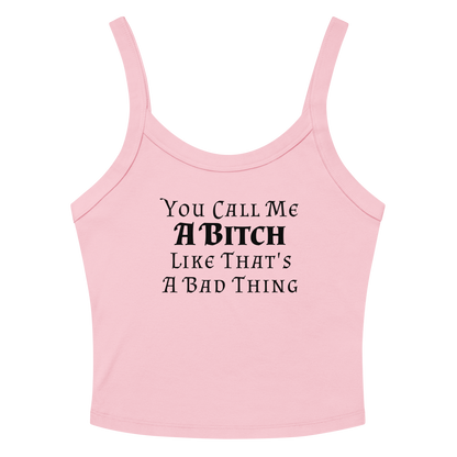 "You Call Me A Bitch Like That's A Bad Thing" printed on a solid pink blend women's micro-rib tanktop laying on a flat surface amongst sunglasses and shorts