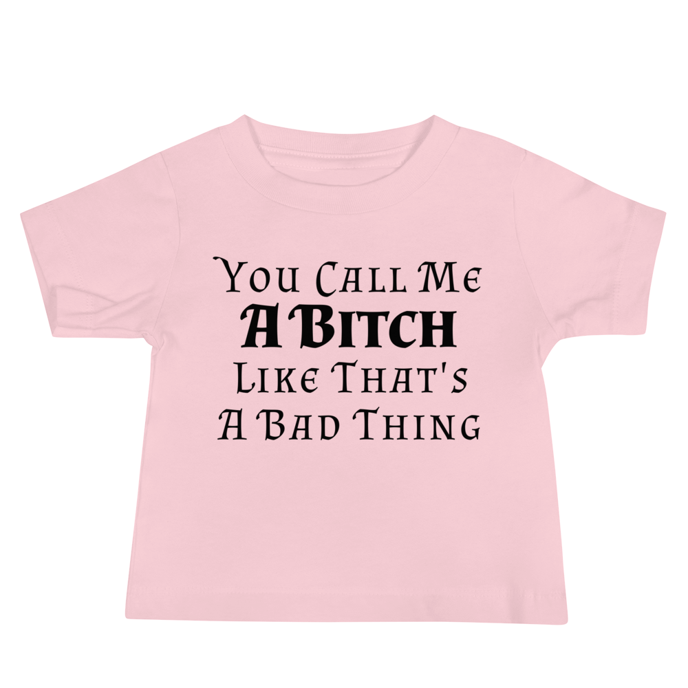"You Call Me A Bitch Like That's A Bad Thing" printed on a pink baby jersey short sleeve tee laying on a flat surface
