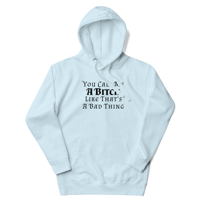 "You Call Me A Bitch Like That's A Bad Thing" printed on a sky blue unisex hoodie laying on a flat surface with the hood up