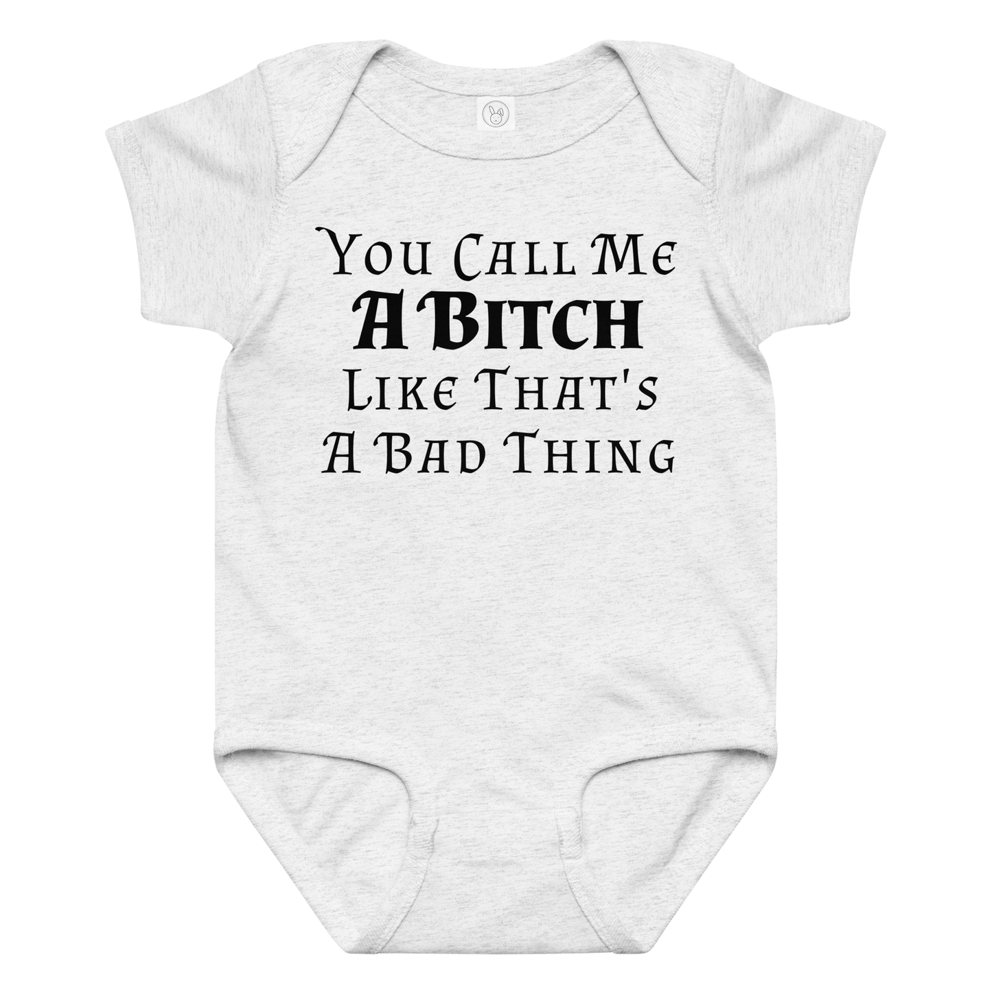 "You Call Me A Bitch Like That's A Bad Thing" printed on a ash baby jersey bodysuit laying on a flat surface amongst other clothes