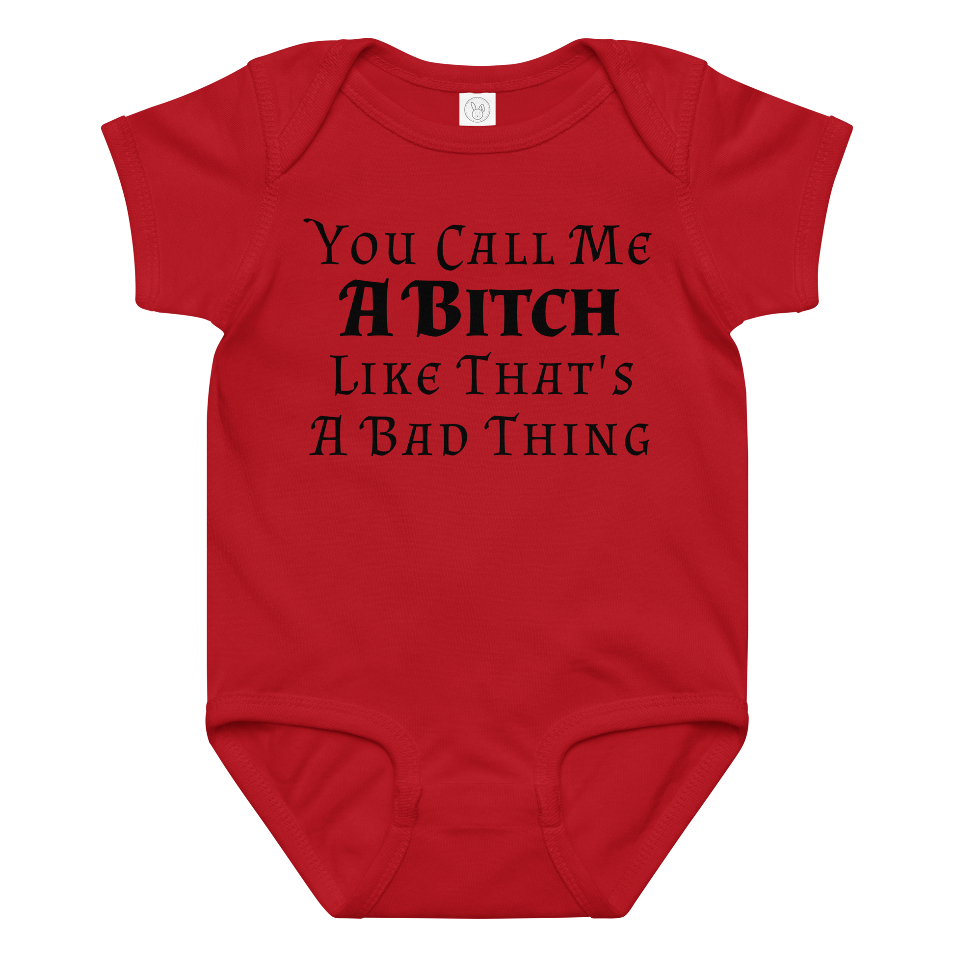 "You Call Me A Bitch Like That's A Bad Thing" printed on a red baby jersey bodysuit laying on a flat surface amongst other clothes