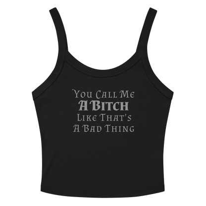 "You Call Me A Bitch Like That's A Bad Thing" printed on a solid black blend women's micro-rib tanktop laying on a flat surface amongst sunglasses and shorts