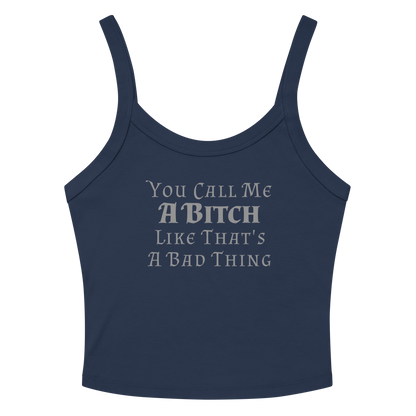 "You Call Me A Bitch Like That's A Bad Thing" printed on a solid navy blend women's micro-rib tanktop laying on a flat surface amongst sunglasses and shorts