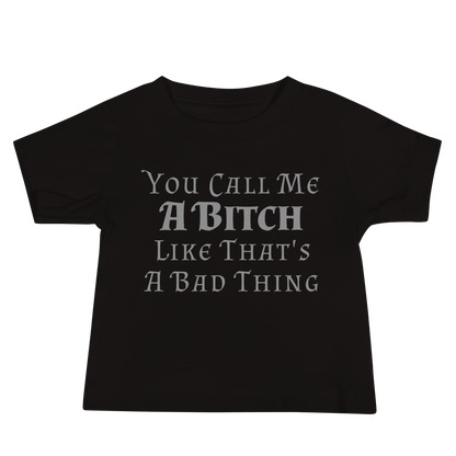 "You Call Me A Bitch Like That's A Bad Thing" printed on a black baby jersey short sleeve tee laying on a flat surface