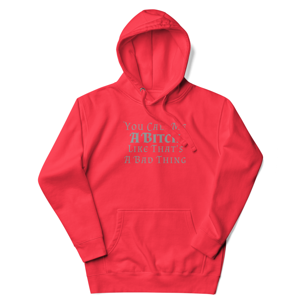"You Call Me A Bitch Like That's A Bad Thing" printed on a team red unisex hoodie laying on a flat surface with the hood up
