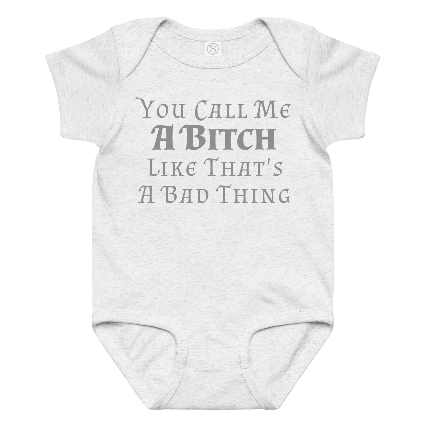 "You Call Me A Bitch Like That's A Bad Thing" printed on a ash baby jersey bodysuit laying on a flat surface amongst other clothes