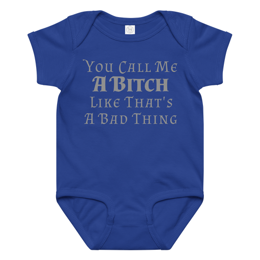 "You Call Me A Bitch Like That's A Bad Thing" printed on a royal baby jersey bodysuit laying on a flat surface amongst other clothes