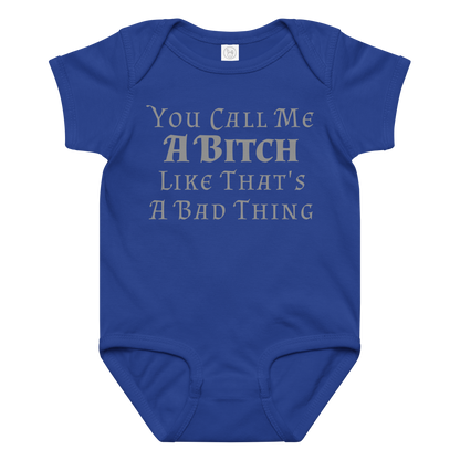 "You Call Me A Bitch Like That's A Bad Thing" printed on a royal baby jersey bodysuit laying on a flat surface amongst other clothes