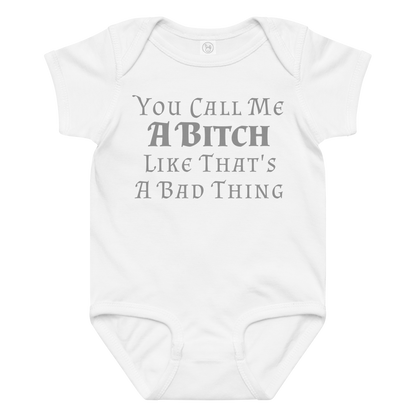 "You Call Me A Bitch Like That's A Bad Thing" printed on a white baby jersey bodysuit laying on a flat surface amongst other clothes