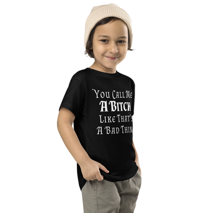 "You Call Me A Bitch Like That's A Bad Thing" printed on a black toddler short sleeve tee worn by a male who is also wearing a knit cap