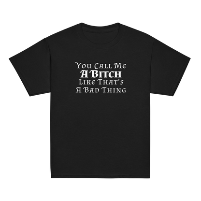 "You Call Me A Bitch Like That's A Bad Thing" printed on a black youth classic tee laying on a flat surface