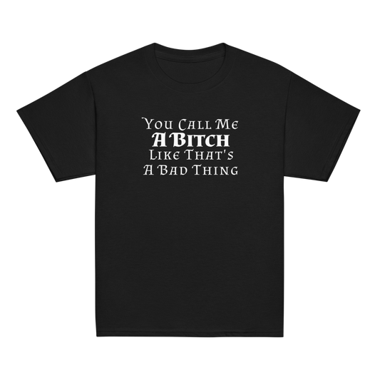 "You Call Me A Bitch Like That's A Bad Thing" printed on a black youth classic tee laying on a flat surface