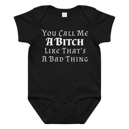 "You Call Me A Bitch Like That's A Bad Thing" printed on a black baby jersey bodysuit laying on a flat surface amongst other clothes