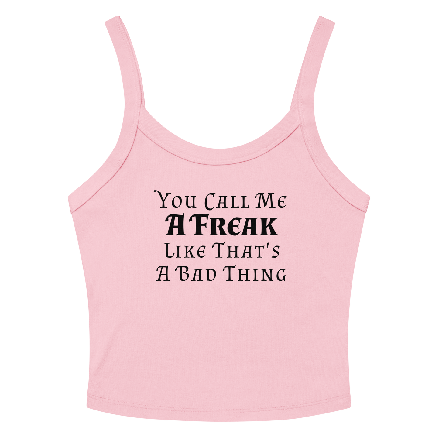 "You Call Me A Freak Like That's A Bad Thing" printed on a solid pink blend women's micro-rib tanktop laying on a flat surface amongst sunglasses and shorts