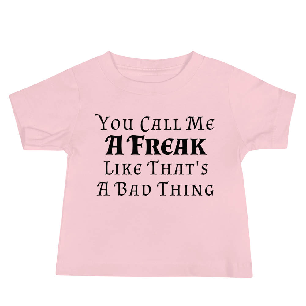 "You Call Me A Freak Like That's A Bad Thing" printed on a pink baby jersey short sleeve tee laying on a flat surface