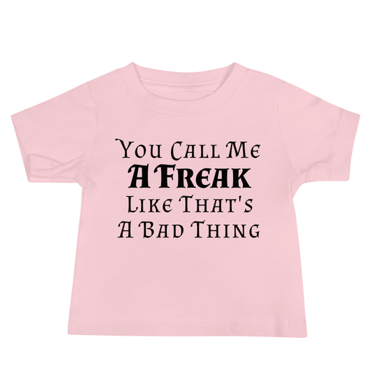 "You Call Me A Freak Like That's A Bad Thing" printed on a pink baby jersey short sleeve tee laying on a flat surface
