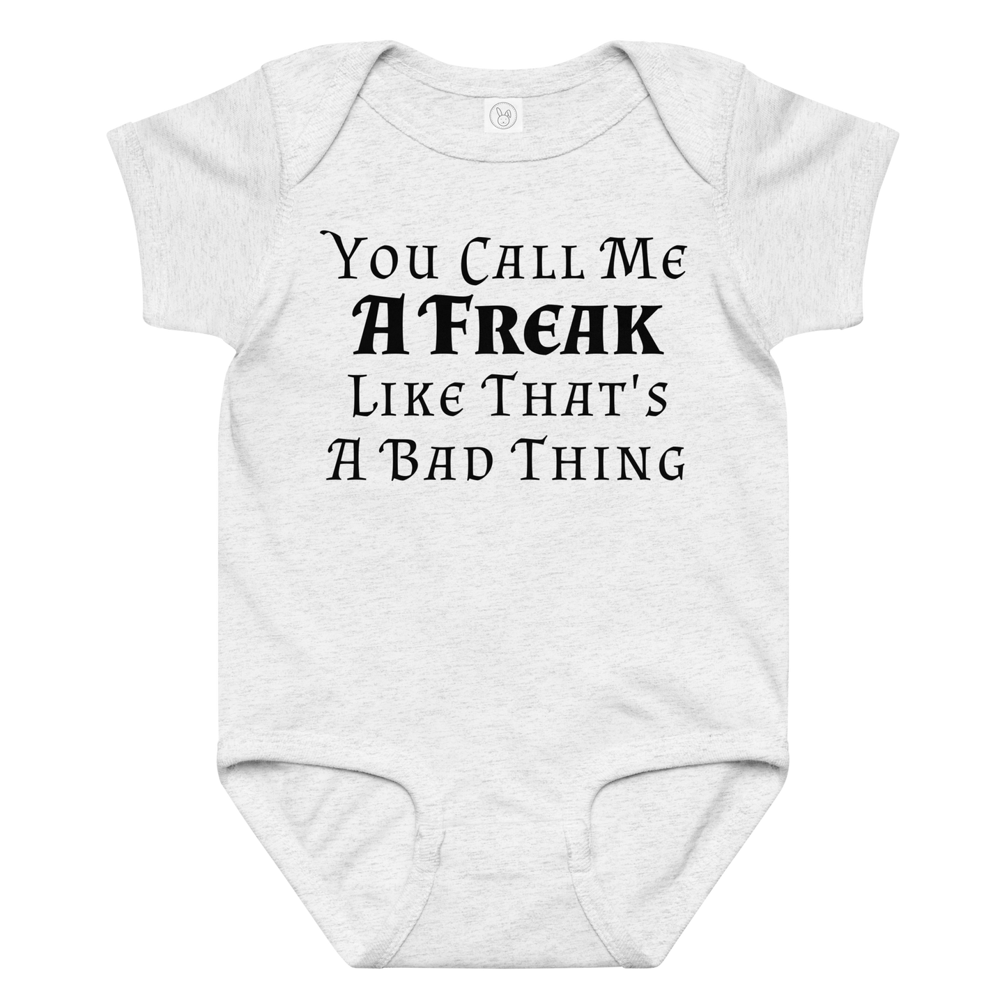 "You Call Me A Freak Like That's A Bad Thing" printed on a ash baby jersey bodysuit laying on a flat surface amongst other clothes