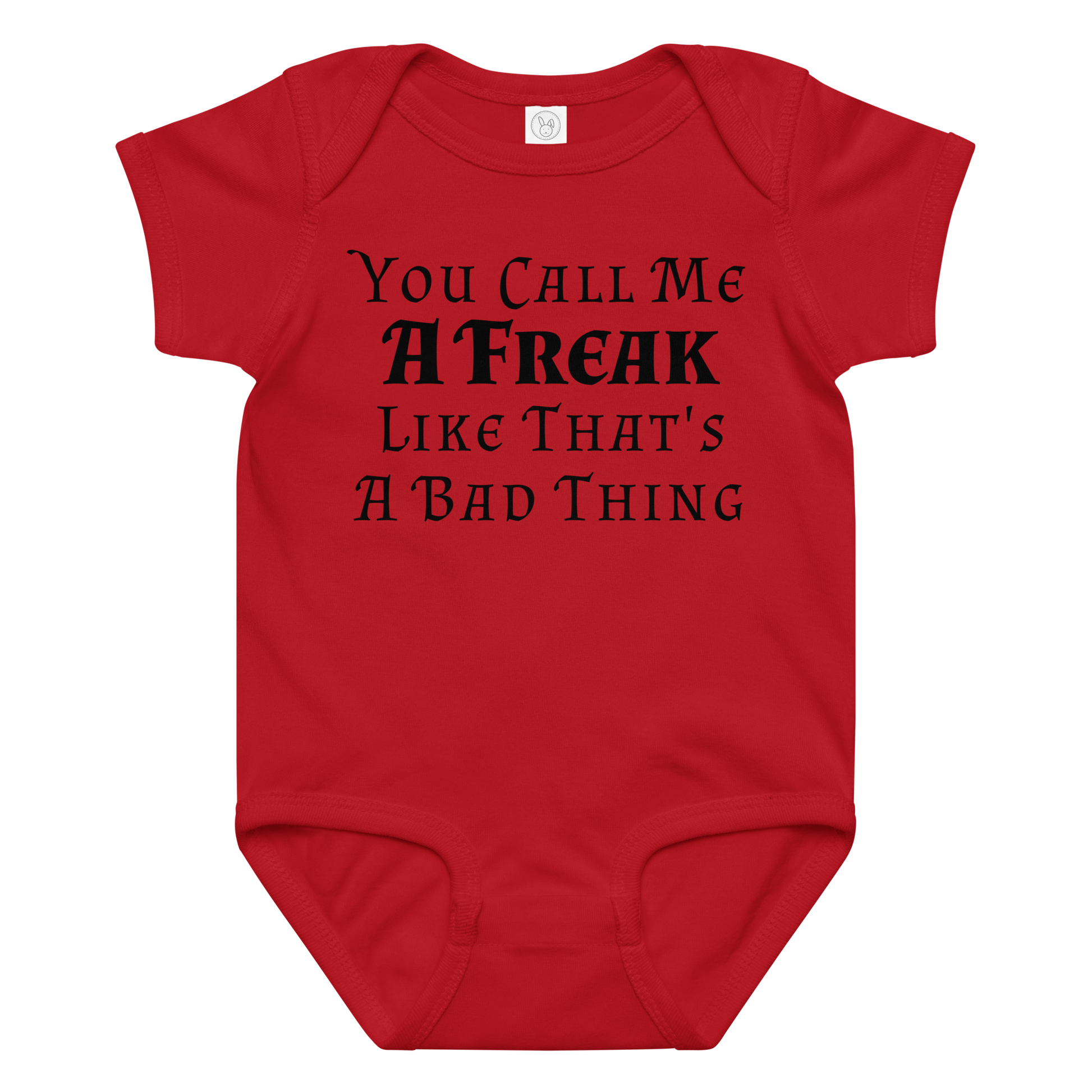 "You Call Me A Freak Like That's A Bad Thing" printed on a red baby jersey bodysuit laying on a flat surface amongst other clothes