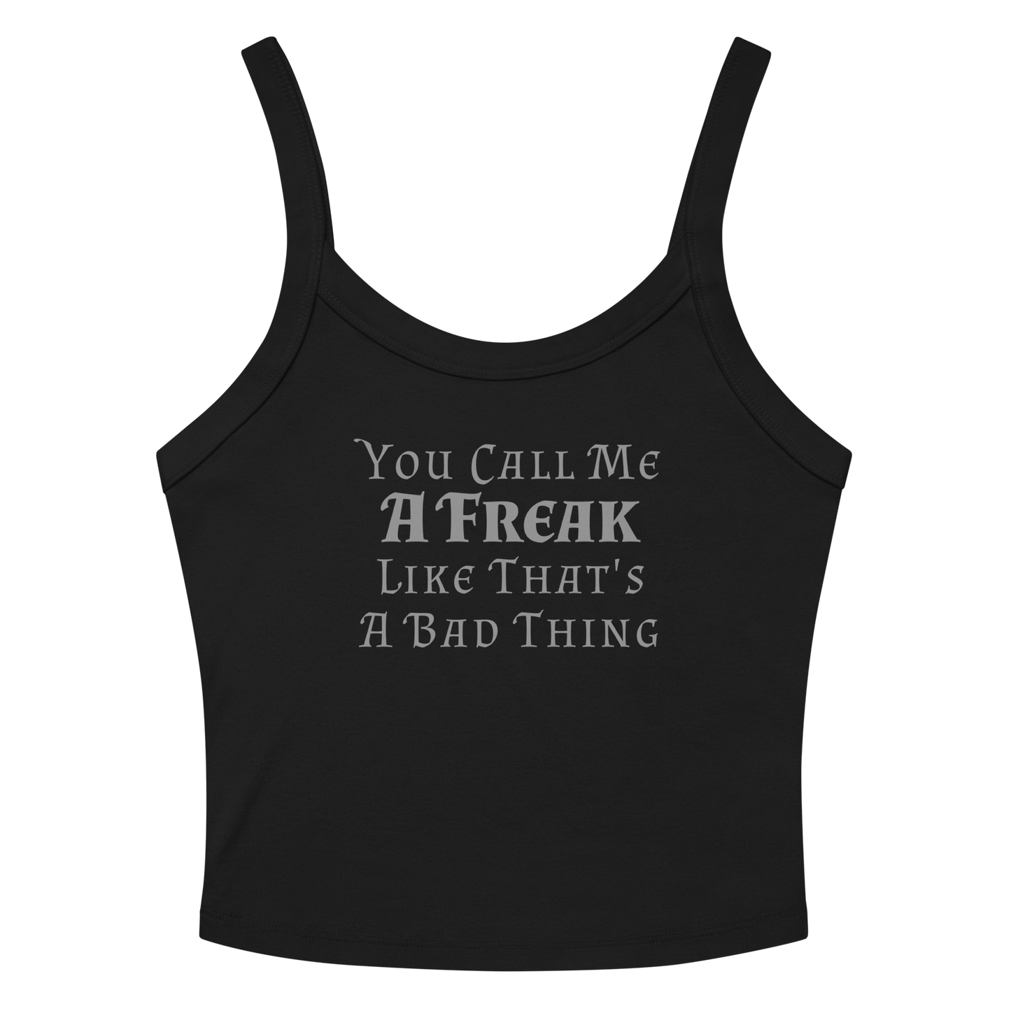 "You Call Me A Freak Like That's A Bad Thing" printed on a solid black blend women's micro-rib tanktop laying on a flat surface amongst sunglasses and shorts