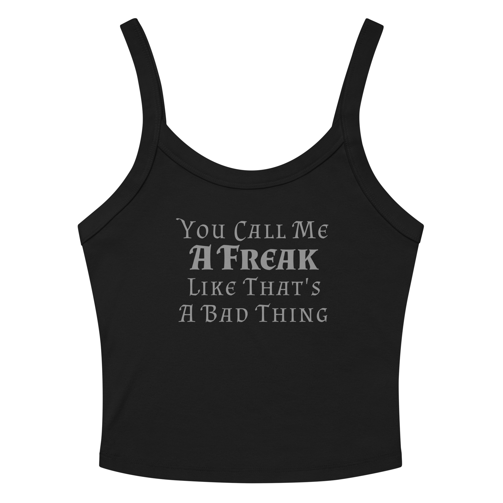 "You Call Me A Freak Like That's A Bad Thing" printed on a solid black blend women's micro-rib tanktop laying on a flat surface amongst sunglasses and shorts