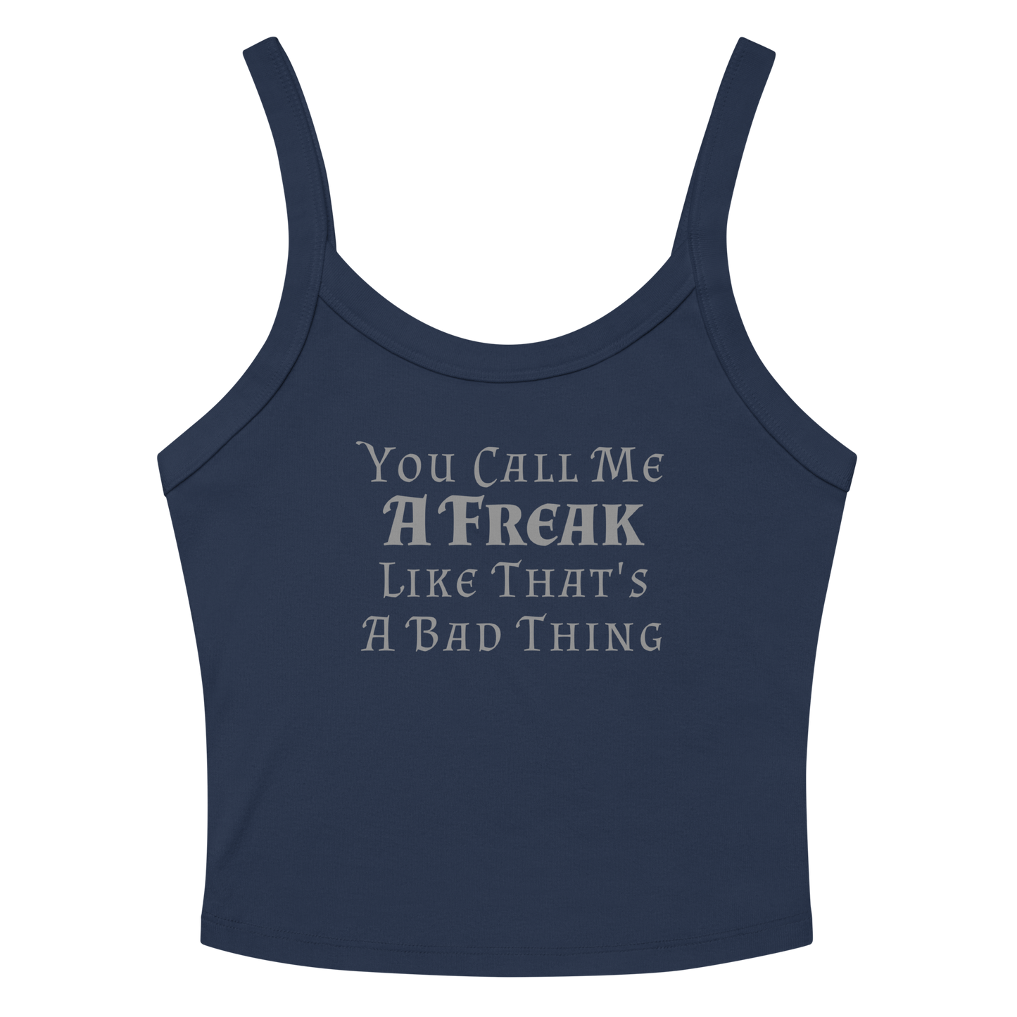 "You Call Me A Freak Like That's A Bad Thing" printed on a solid navy blend women's micro-rib tanktop laying on a flat surface amongst sunglasses and shorts