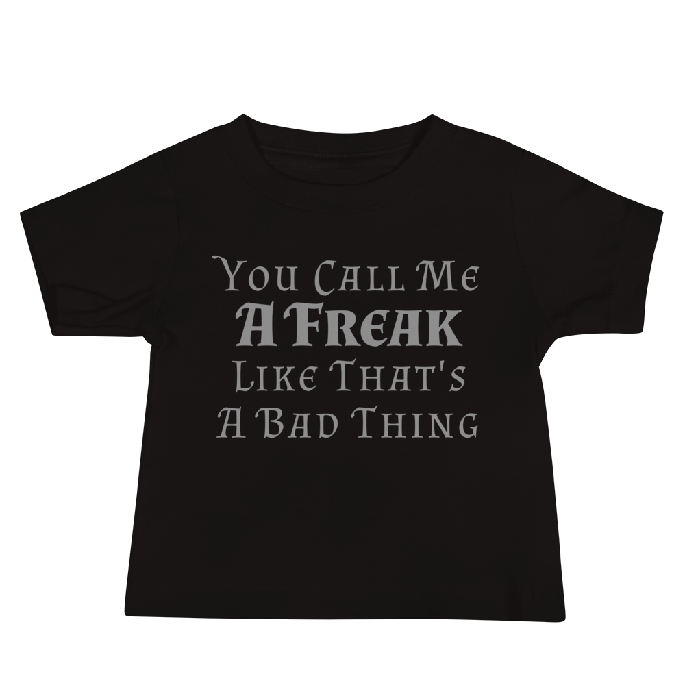 "You Call Me A Freak Like That's A Bad Thing" printed on a black baby jersey short sleeve tee laying on a flat surface