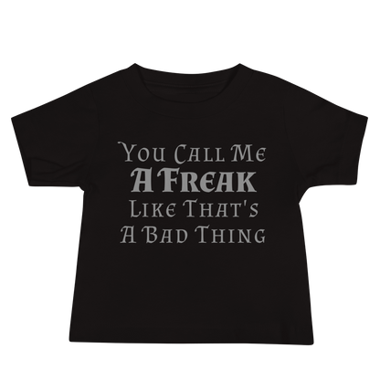 "You Call Me A Freak Like That's A Bad Thing" printed on a black baby jersey short sleeve tee laying on a flat surface