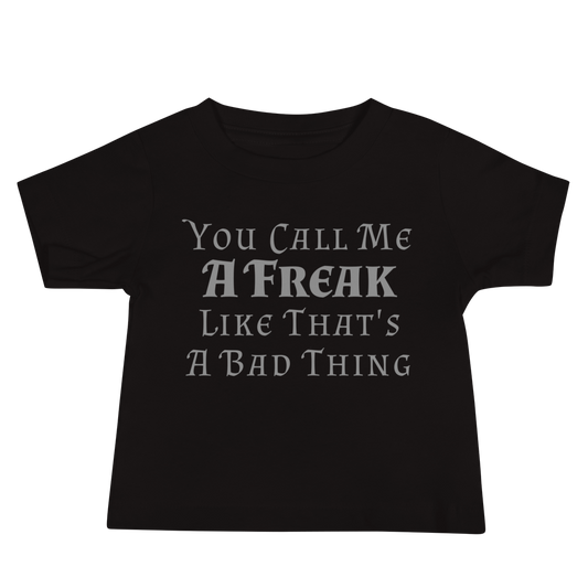 "You Call Me A Freak Like That's A Bad Thing" printed on a black baby jersey short sleeve tee laying on a flat surface