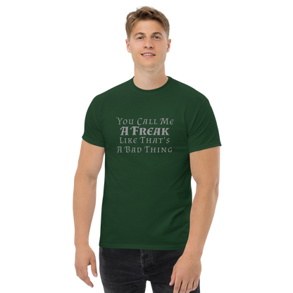 "You Call Me A Freak Like That's A Bad Thing" printed on a forest green unisex classic tee worn by a male