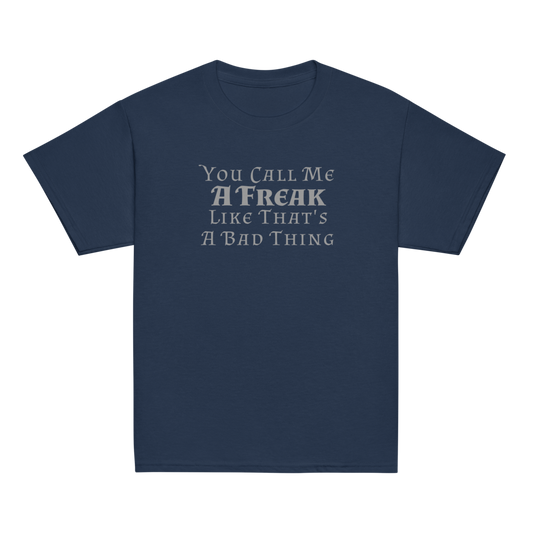 "You Call Me A Freak Like That's A Bad Thing" printed on a navy youth classic tee laying on a flat surface