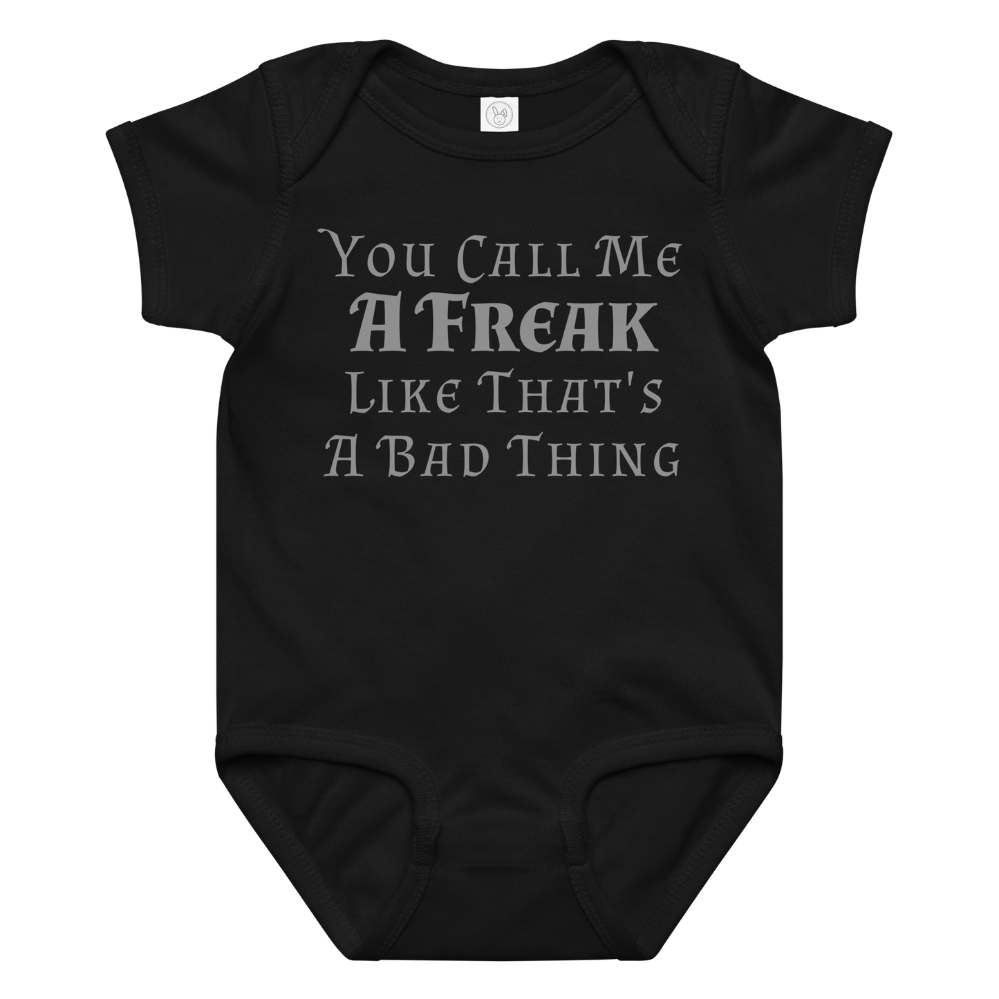 "You Call Me A Freak Like That's A Bad Thing" printed on a black baby jersey bodysuit laying on a flat surface amongst other clothes