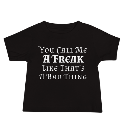 "You Call Me A Freak Like That's A Bad Thing" printed on a black baby jersey short sleeve tee laying on a flat surface