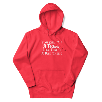 "You Call Me A Freak Like That's A Bad Thing" printed on a team red unisex hoodie laying on a flat surface with the hood up