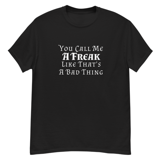 "You Call Me A Freak Like That's A Bad Thing" printed on a black unisex classic tee laying on a flat surface