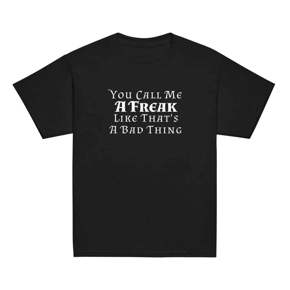 "You Call Me A Freak Like That's A Bad Thing" printed on a black youth classic tee laying on a flat surface