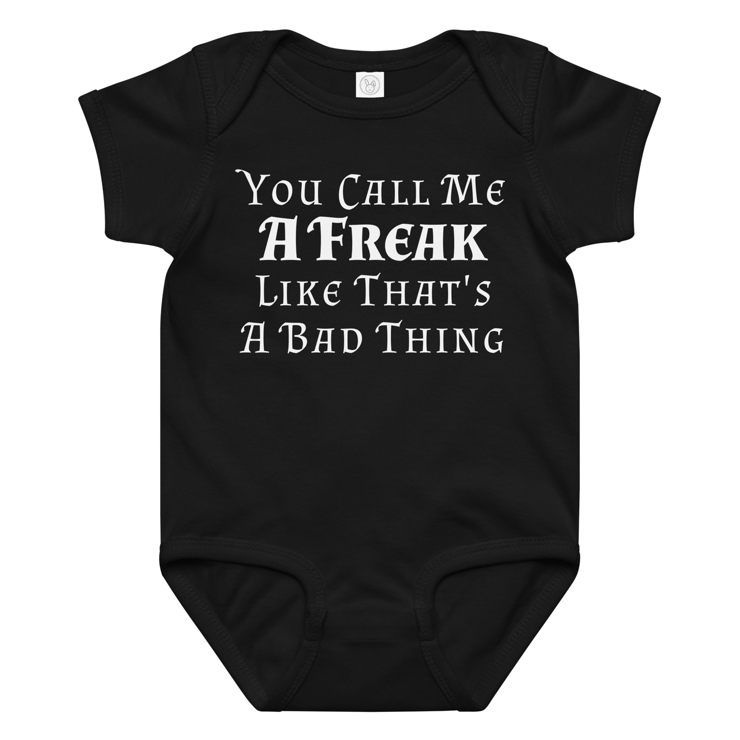 "You Call Me A Freak Like That's A Bad Thing" printed on a black baby jersey bodysuit laying on a flat surface amongst other clothes