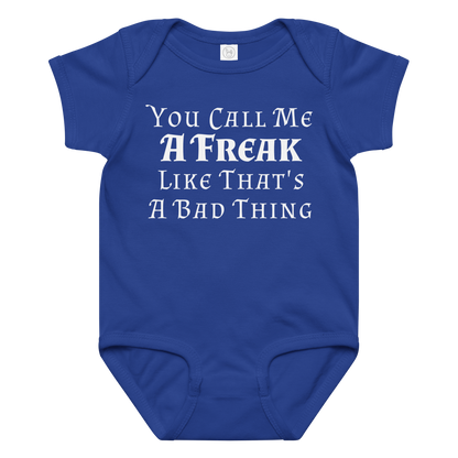 "You Call Me A Freak Like That's A Bad Thing" printed on a royal baby jersey bodysuit laying on a flat surface amongst other clothes
