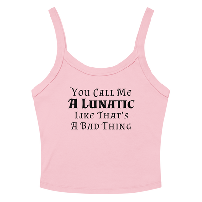 "You Call Me A Lunatic Like That's A Bad Thing" printed on a solid pink blend women's micro-rib tanktop laying on a flat surface amongst sunglasses and shorts