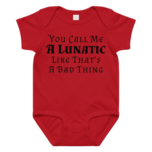 "You Call Me A Lunatic Like That's A Bad Thing" printed on a red baby jersey bodysuit laying on a flat surface amongst other clothes