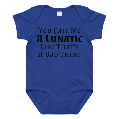 "You Call Me A Lunatic Like That's A Bad Thing" printed on a royal baby jersey bodysuit laying on a flat surface amongst other clothes