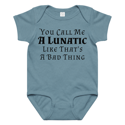 "You Call Me A Lunatic Like That's A Bad Thing" printed on a vintage indigo baby jersey bodysuit laying on a flat surface amongst other clothes