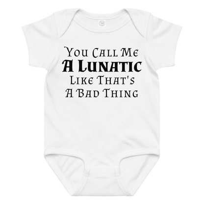 "You Call Me A Lunatic Like That's A Bad Thing" printed on a white baby jersey bodysuit laying on a flat surface amongst other clothes