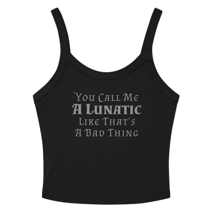 "You Call Me A Lunatic Like That's A Bad Thing" printed on a solid black blend women's micro-rib tanktop laying on a flat surface amongst sunglasses and shorts