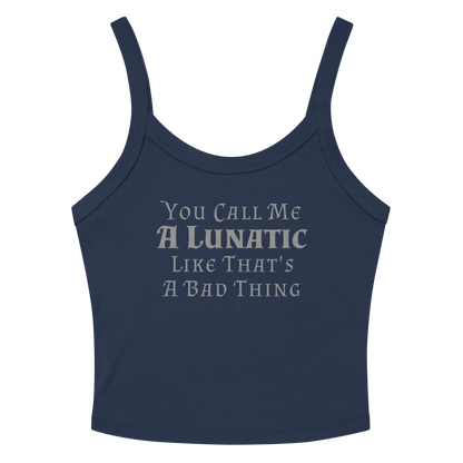 "You Call Me A Lunatic Like That's A Bad Thing" printed on a solid navy blend women's micro-rib tanktop laying on a flat surface amongst sunglasses and shorts