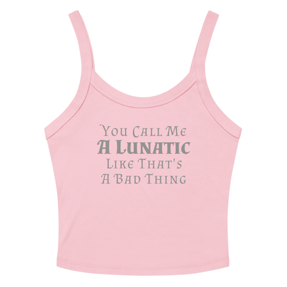 "You Call Me A Lunatic Like That's A Bad Thing" printed on a solid pink blend women's micro-rib tanktop laying on a flat surface amongst sunglasses and shorts
