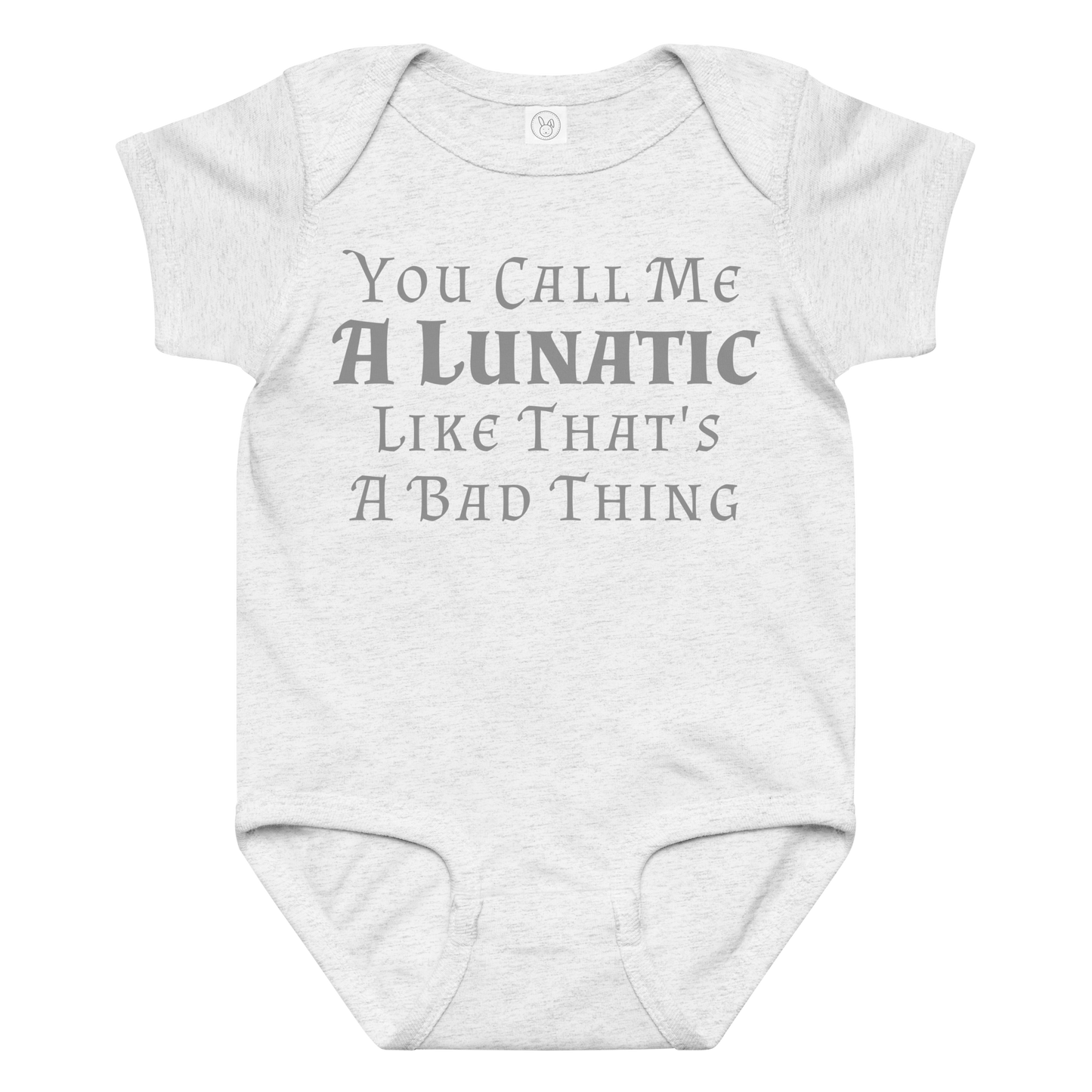 "You Call Me A Lunatic Like That's A Bad Thing" printed on a ash baby jersey bodysuit laying on a flat surface amongst other clothes